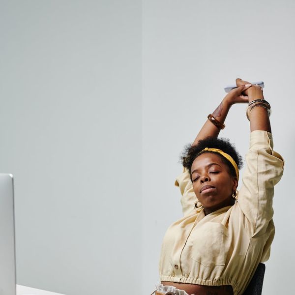 A person sitting peacefully with eyes closed, embodying well-being.